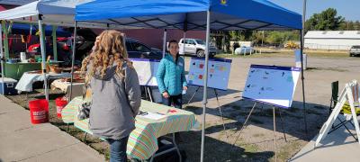 Picture of Cameron McCarthy at the Chiloquin Farmers Market collecting community feedback