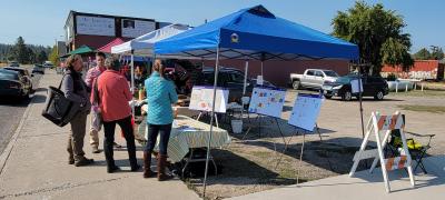Picture of Cameron McCarthy at the Chiloquin Farmers Market collecting community feedback