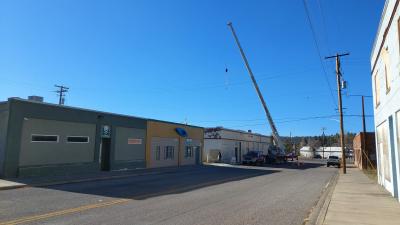 Crane lifting new AC components onto roof
